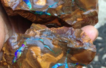 Further cutting to reveal bright seams of opal