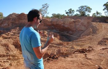 Finding the opal seam underground with divining rods.