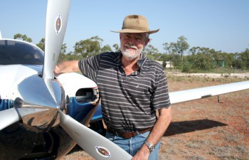 Max Lane next to his Plane on an outback runway